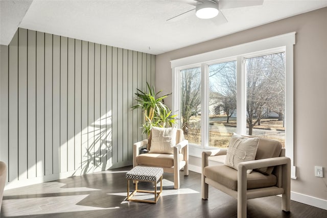 sitting room with hardwood / wood-style flooring, a textured ceiling, and ceiling fan