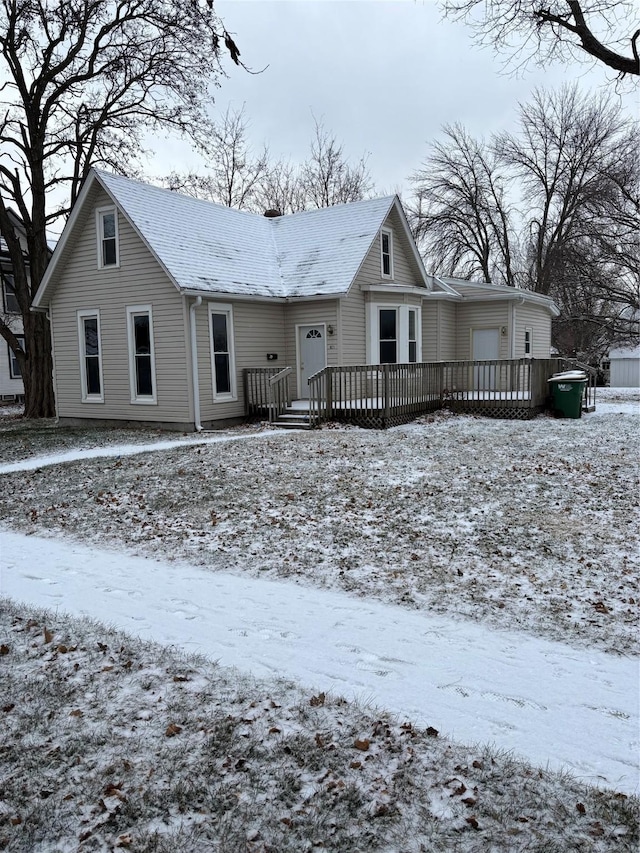 view of snow covered back of property