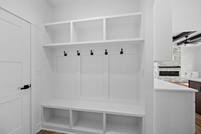 mudroom with dark hardwood / wood-style floors and ceiling fan