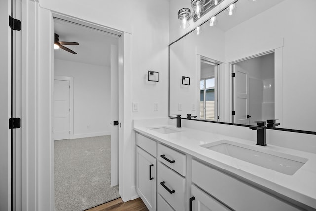 bathroom with ceiling fan, hardwood / wood-style floors, and vanity