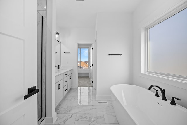 bathroom with vanity and a bath