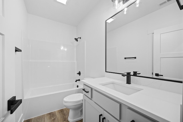 full bathroom with wood finished floors, toilet, bathing tub / shower combination, and vanity