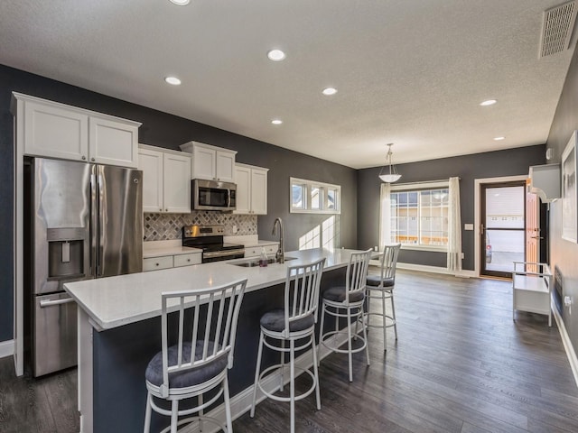 kitchen with white cabinets, dark hardwood / wood-style flooring, stainless steel appliances, and sink