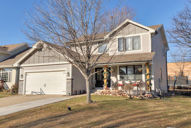 craftsman house featuring a front yard, a porch, a trampoline, and a garage