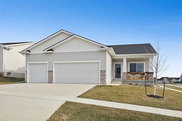 view of front of property with covered porch, a front yard, and a garage