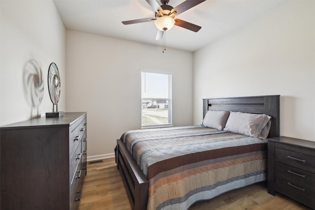 bedroom featuring dark hardwood / wood-style flooring and ceiling fan