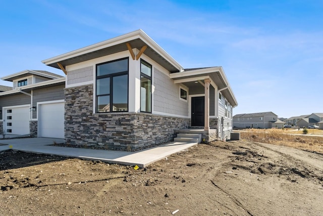 view of front of home featuring stone siding and central AC