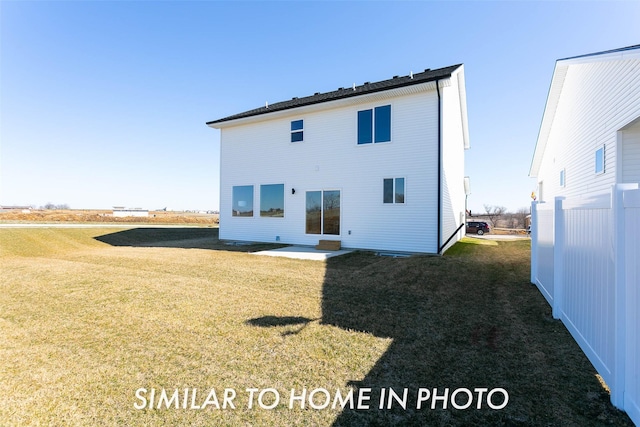 rear view of property featuring a lawn