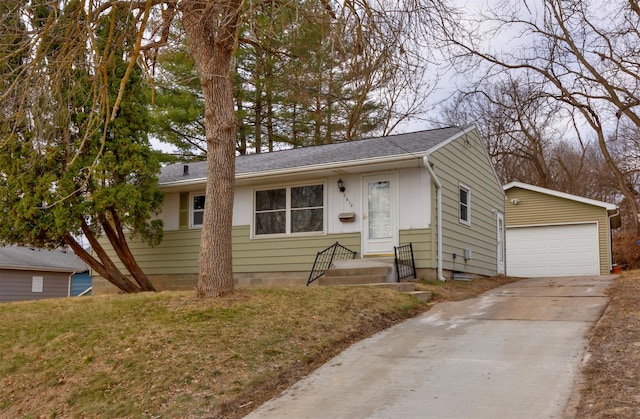 view of front of house featuring a garage, roof with shingles, and an outdoor structure