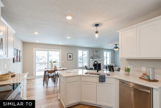 kitchen featuring pendant lighting, dishwasher, sink, ceiling fan, and white cabinetry