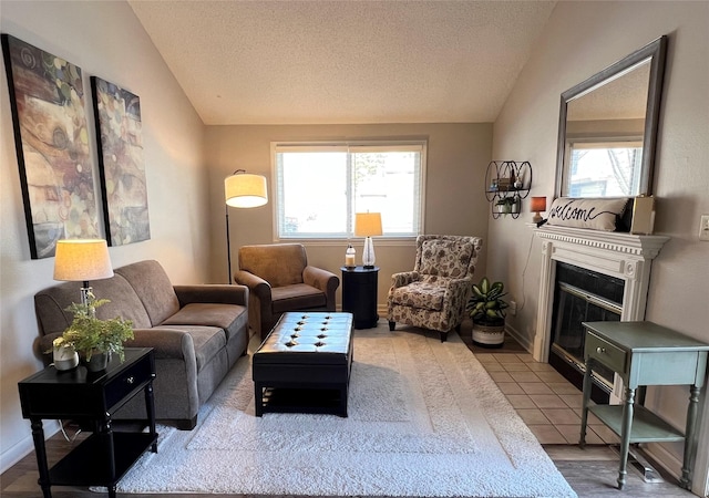 tiled living room with a textured ceiling, vaulted ceiling, and a healthy amount of sunlight