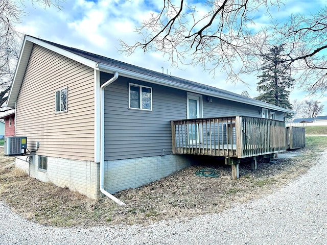 view of side of property featuring cooling unit and a deck