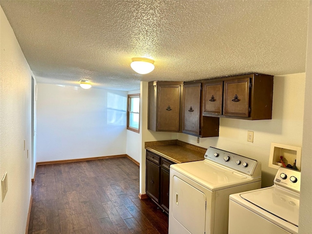 laundry area with a textured ceiling, cabinets, independent washer and dryer, and dark wood-type flooring