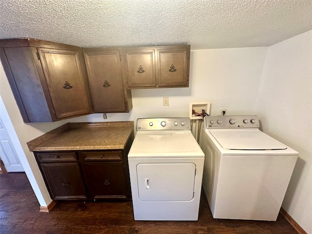 laundry room featuring cabinets, a textured ceiling, and washing machine and dryer