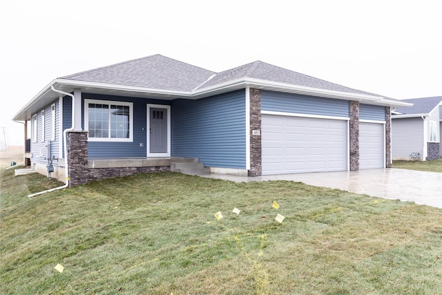 ranch-style house featuring a front yard and a garage