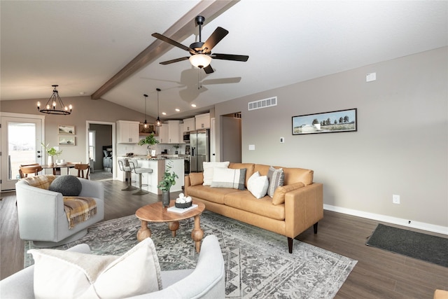 living room with vaulted ceiling with beams, ceiling fan with notable chandelier, and dark hardwood / wood-style floors