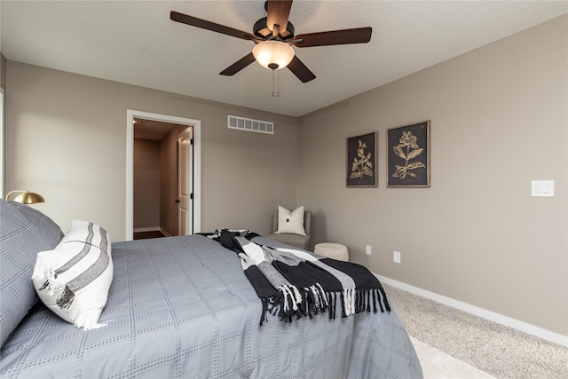 bedroom with carpet flooring, a textured ceiling, and ceiling fan