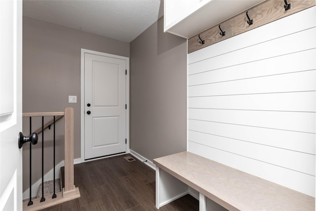 mudroom with dark hardwood / wood-style flooring and a textured ceiling