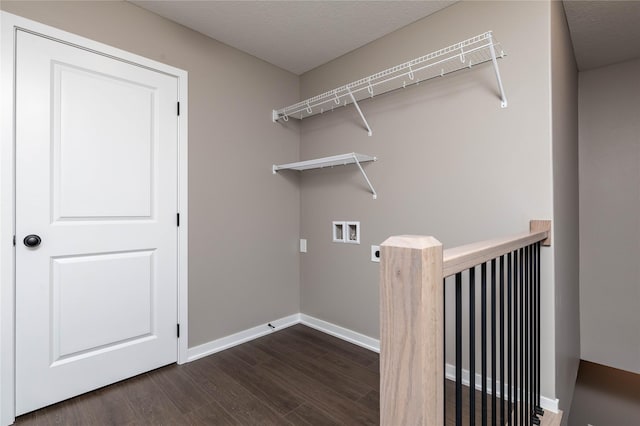 laundry room with electric dryer hookup, dark hardwood / wood-style flooring, a textured ceiling, and hookup for a washing machine