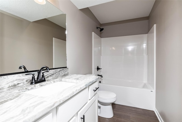 full bathroom with vanity, wood-type flooring, tub / shower combination, and toilet