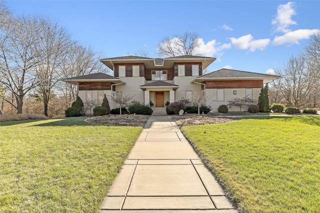 prairie-style house featuring a front yard and stucco siding