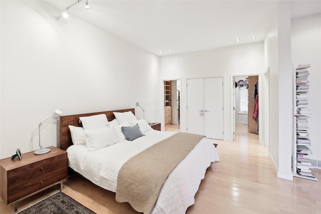 bedroom featuring light wood-type flooring, ensuite bathroom, and recessed lighting