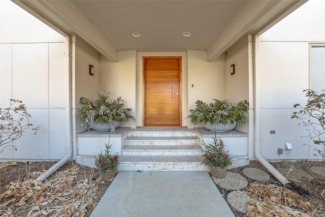 entrance to property featuring stucco siding