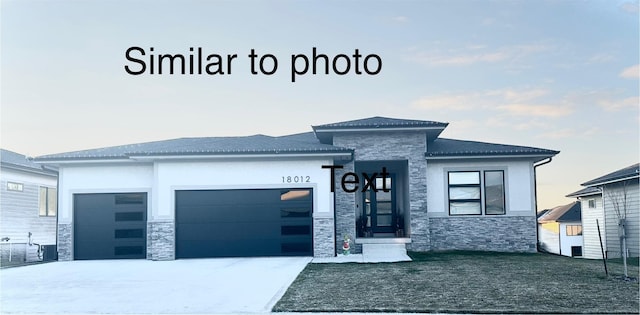 view of front of property with a front yard and a garage