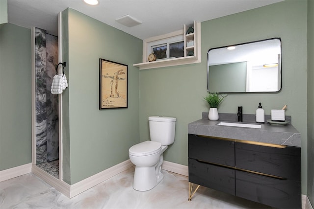 bathroom featuring vanity, toilet, and walk in shower