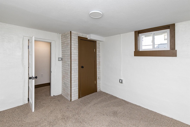 unfurnished bedroom featuring a textured ceiling and light carpet