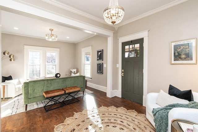 entryway with crown molding, dark hardwood / wood-style flooring, and a notable chandelier