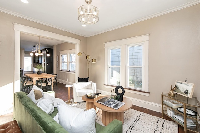 living room featuring dark hardwood / wood-style floors, an inviting chandelier, and ornamental molding