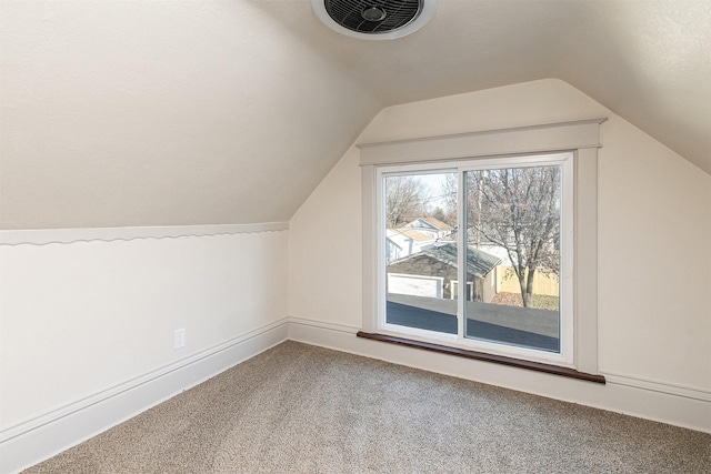 bonus room with carpet flooring and lofted ceiling