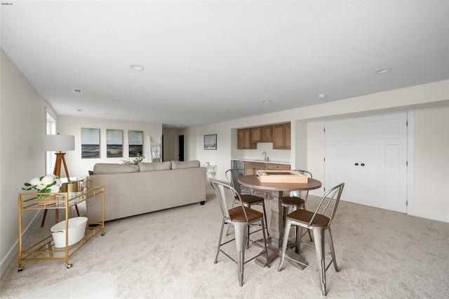 carpeted dining space with sink