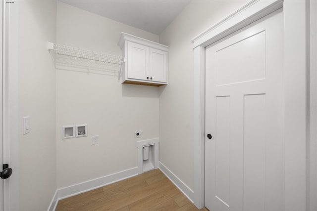 clothes washing area featuring cabinets, hookup for a washing machine, light hardwood / wood-style flooring, and hookup for an electric dryer