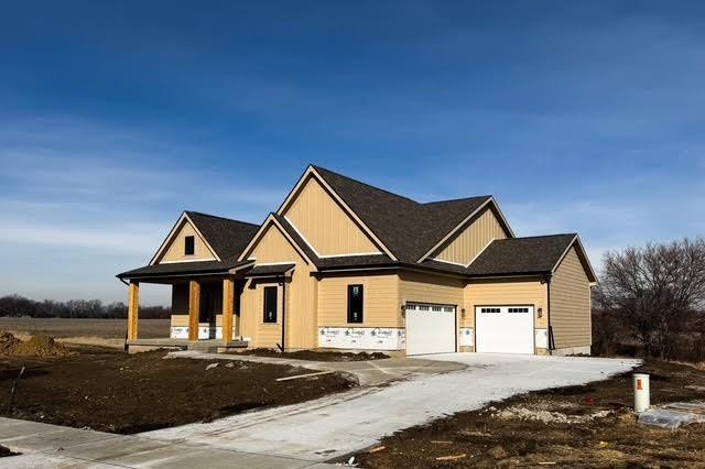 view of front of house featuring a porch and a garage