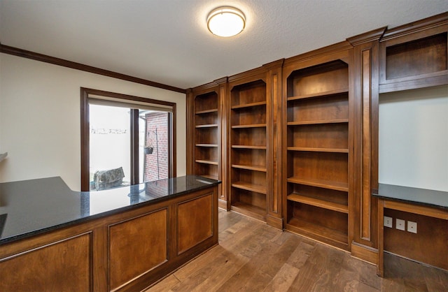 unfurnished office featuring crown molding, dark hardwood / wood-style flooring, and a textured ceiling