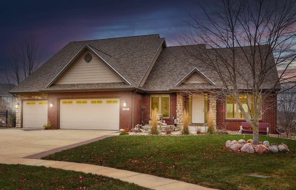 craftsman-style house with a lawn and a garage