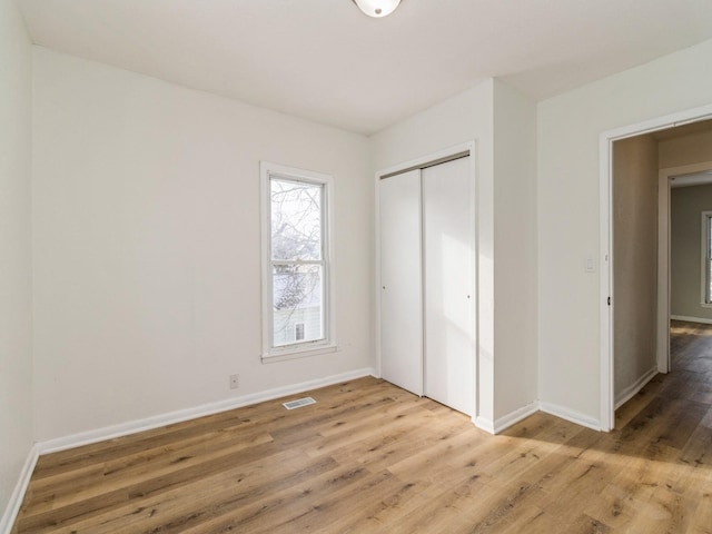 unfurnished bedroom featuring a closet and wood-type flooring