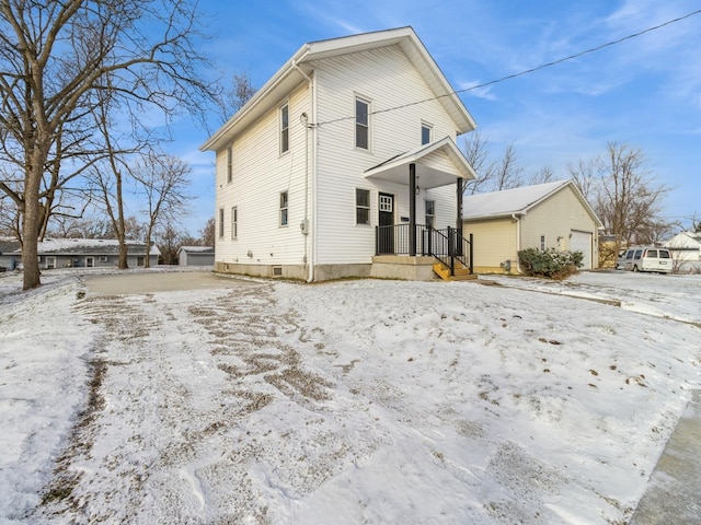 snow covered property featuring a garage