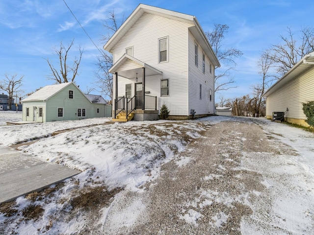 snow covered property with cooling unit