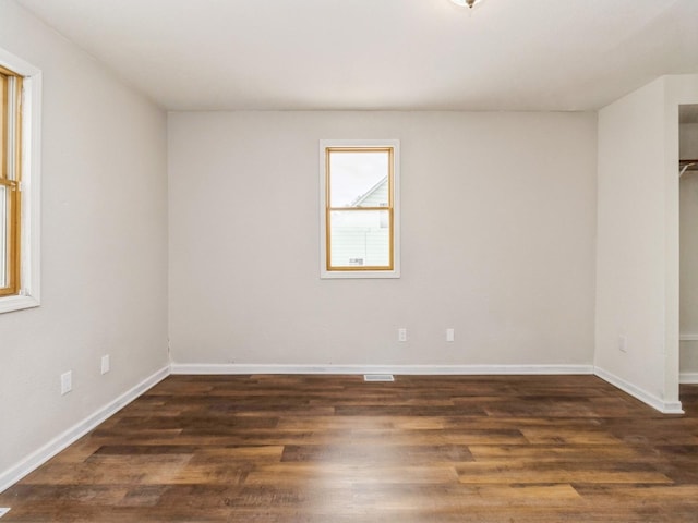 unfurnished room featuring dark hardwood / wood-style floors