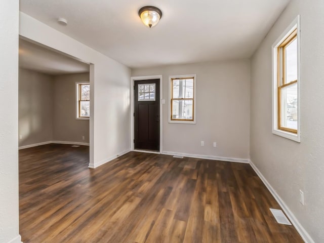 entryway with a healthy amount of sunlight and dark wood-type flooring