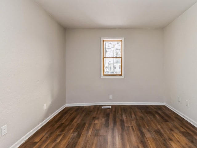 empty room with dark hardwood / wood-style floors