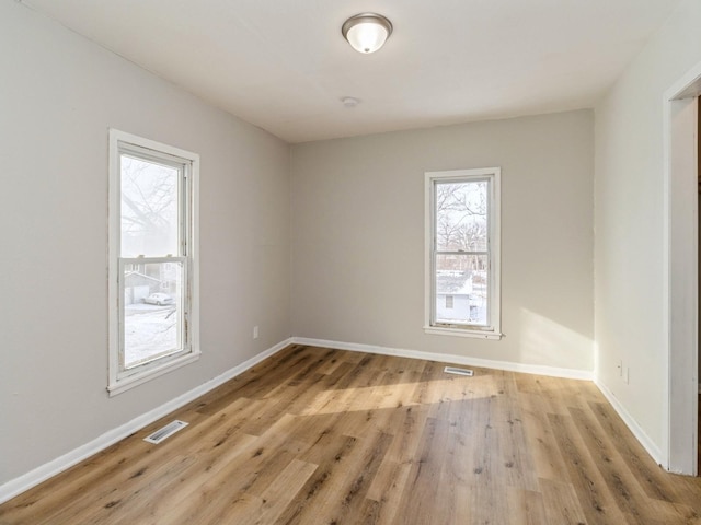 empty room with a healthy amount of sunlight and light wood-type flooring