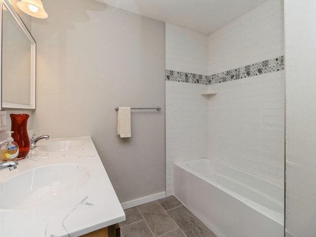 bathroom with vanity and tiled shower / bath