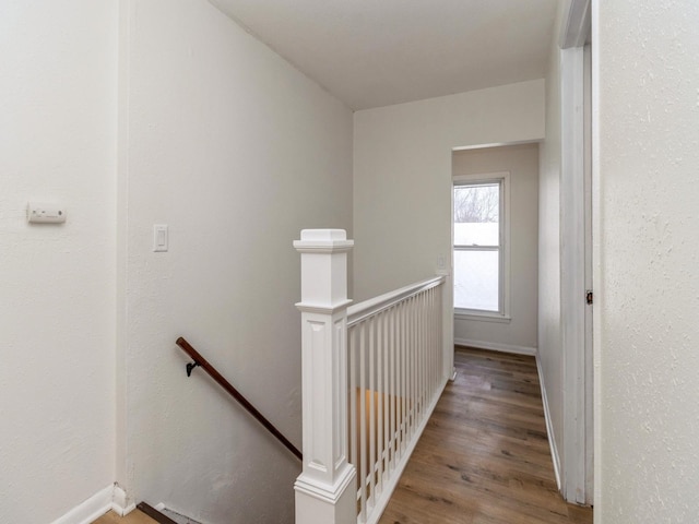 corridor with hardwood / wood-style flooring