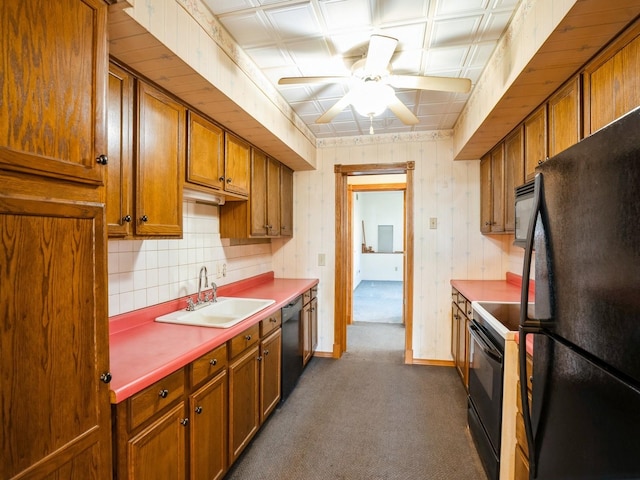 kitchen featuring ceiling fan, sink, dark colored carpet, decorative backsplash, and black appliances