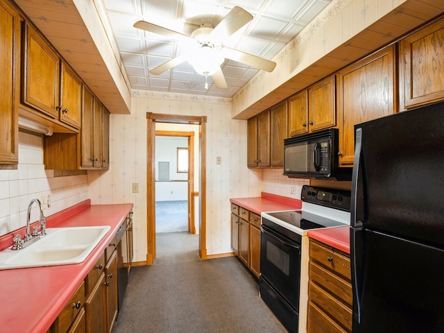 kitchen with ceiling fan, sink, black appliances, and dark carpet