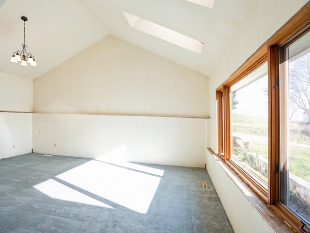 additional living space with dark colored carpet, vaulted ceiling with skylight, and a notable chandelier